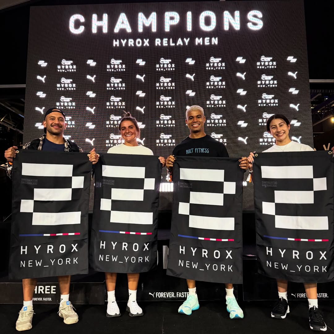 Coach Josh, Coach Dana, Coach Sebastian, and Amy on the podium at HYROX NYC 2026 Team Relay Mixed