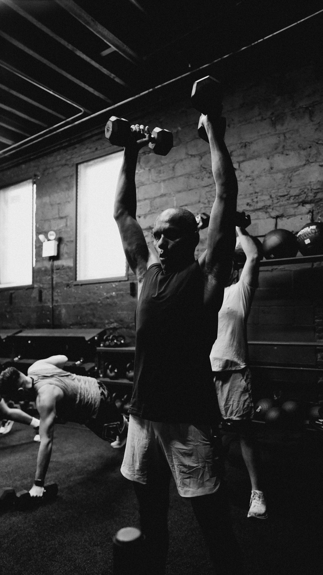 Group overhead press during a BOLT Fitness strength session