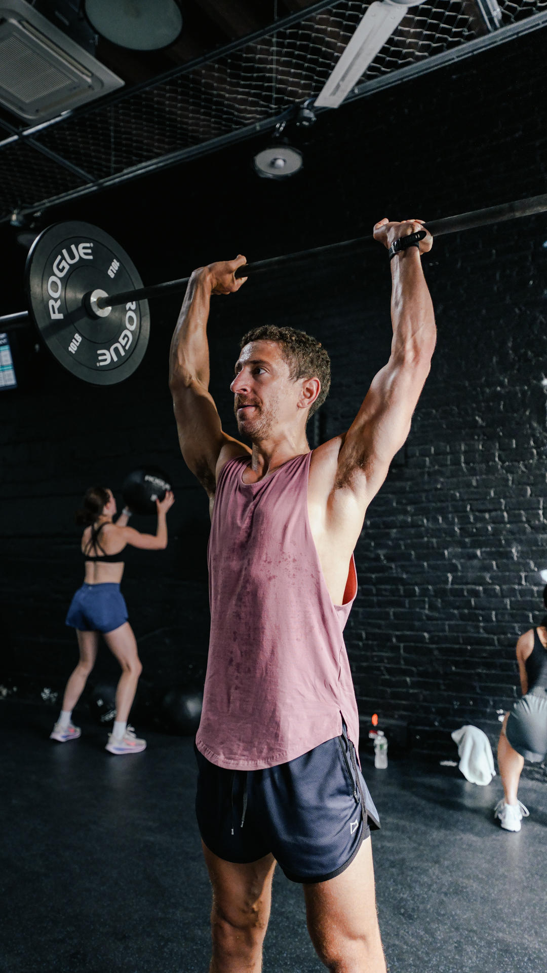 Athlete overhead pressing at BOLT Fitness
