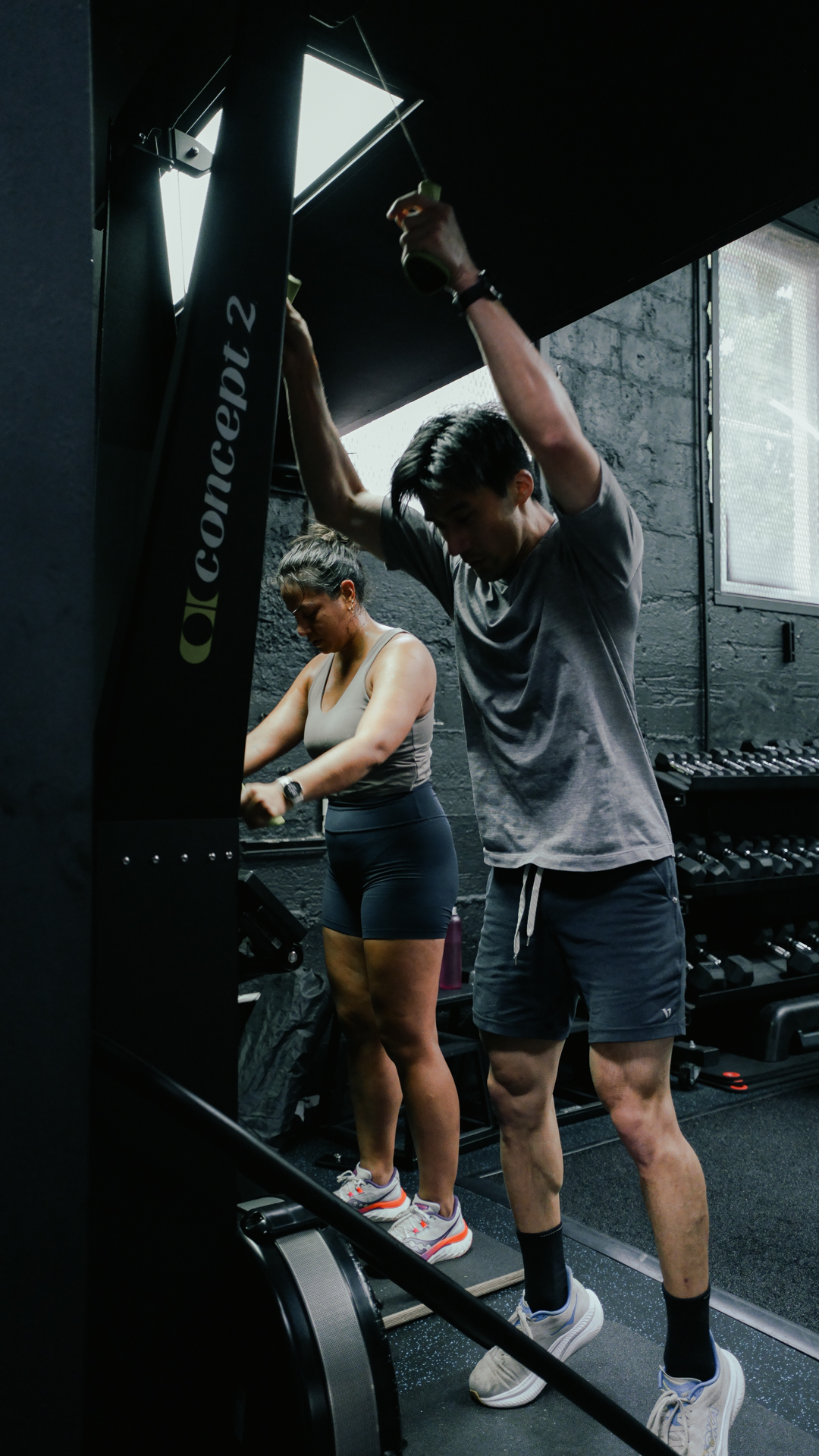 Two athletes on the SkiErg at BOLT Fitness